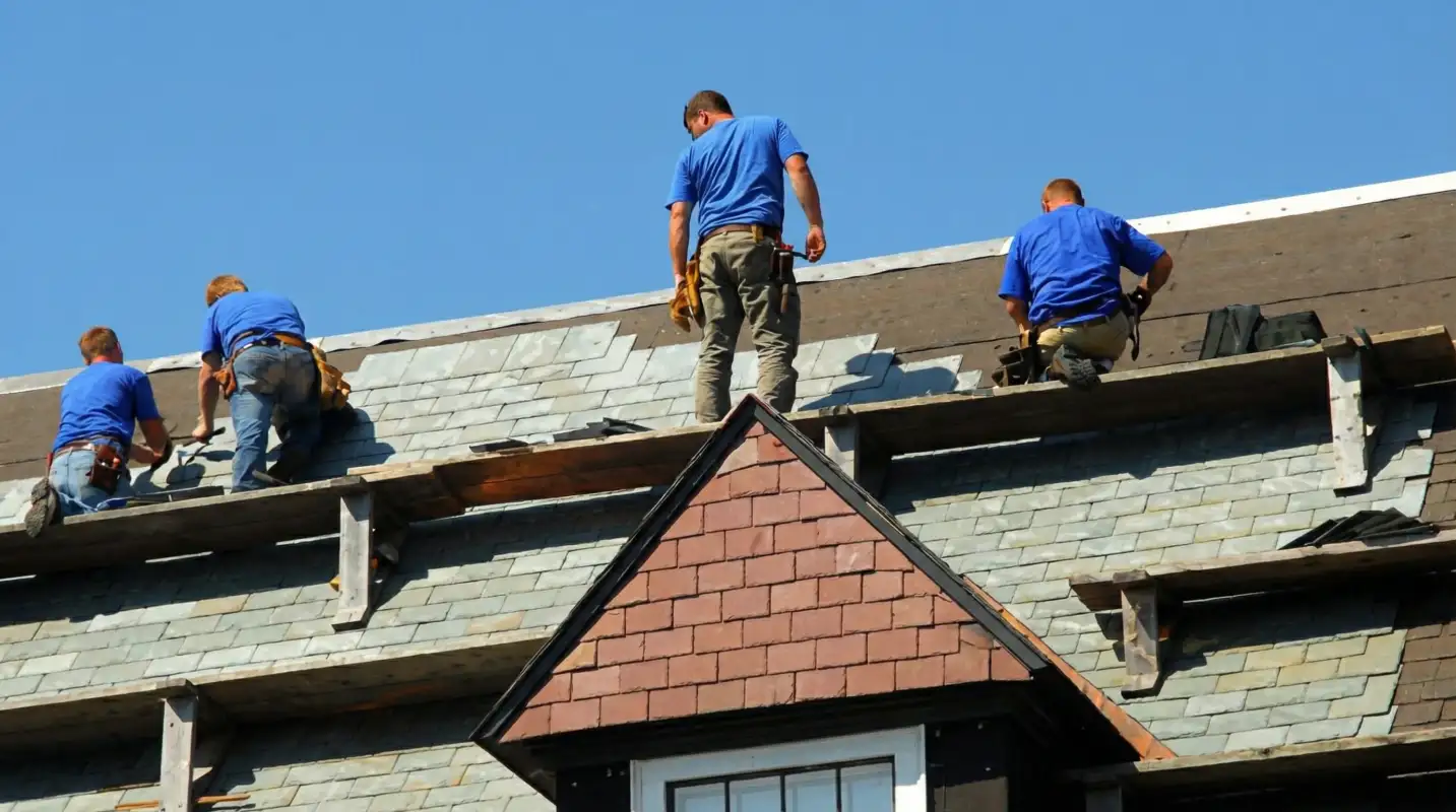 Roof replacement in progress with a team of professional contractors installing new shingles on a residential home in Norfolk, VA