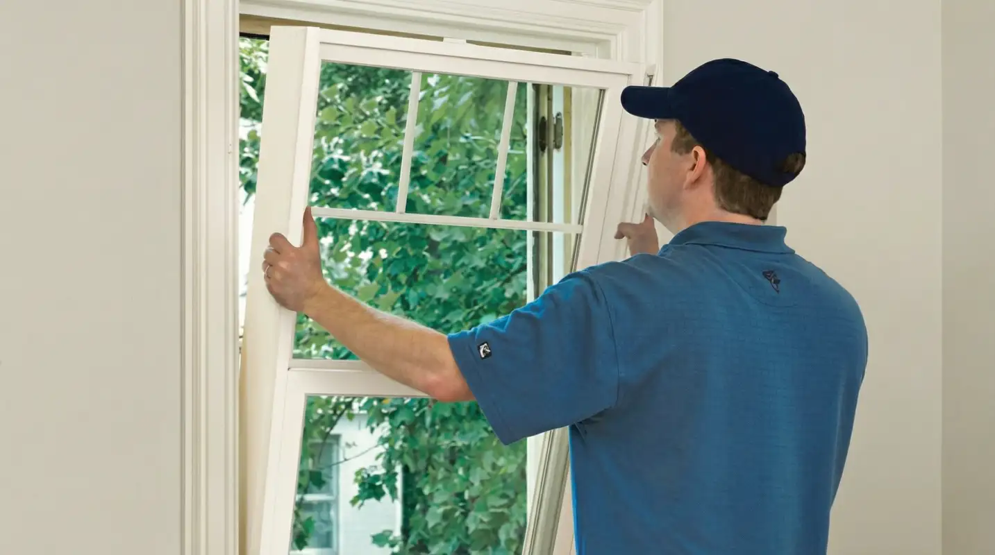 Professional contractors performing a residential window insulation and replacement service in Norfolk, VA